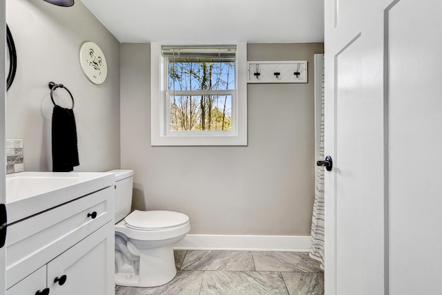 4371 N 68th Ave, Hart, MI 49420 - bathroom featuring vanity, toilet, baseboards, and marble finish flooring