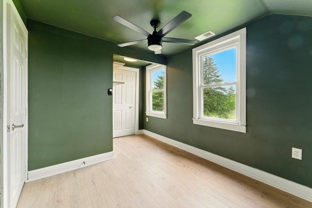 8075 Burlingame Ave SW, Byron Center, MI 49315 - spare room with a ceiling fan, light wood-type flooring, baseboards, and vaulted ceiling