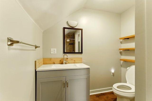 8075 Burlingame Ave SW, Byron Center, MI 49315 - bathroom featuring vaulted ceiling, vanity, wood finished floors, toilet, and baseboards