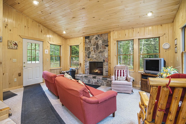 4900 N Railroad Ave, Pentwater, MI 49449 - carpeted living area with wood ceiling, wood walls, a fireplace, lofted ceiling, and baseboards