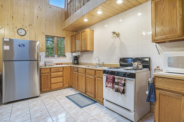 4900 N Railroad Ave, Pentwater, MI 49449 - kitchen with white appliances, a sink, light countertops, tasteful backsplash, and healthy amount of natural light