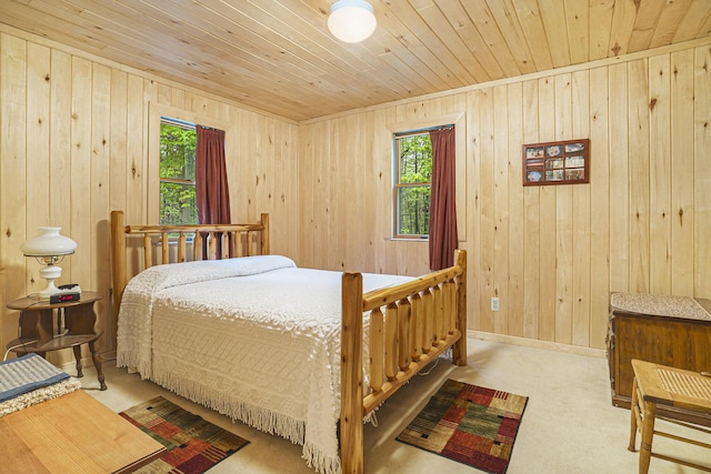 4900 N Railroad Ave, Pentwater, MI 49449 - bedroom with wooden ceiling, wooden walls, carpet, and baseboards