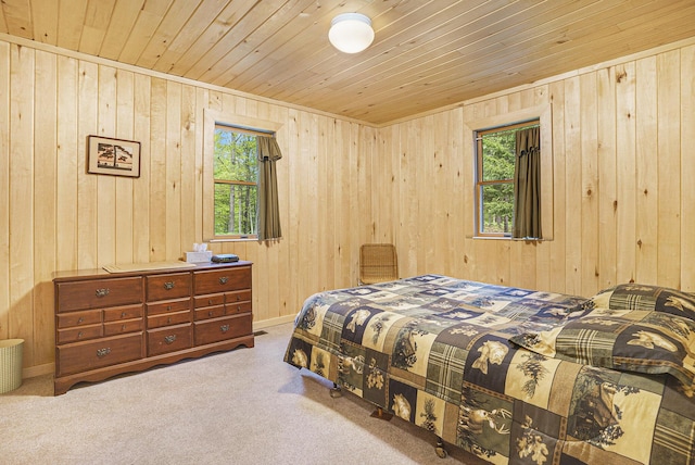 4900 N Railroad Ave, Pentwater, MI 49449 - carpeted bedroom featuring multiple windows, wooden walls, and wood ceiling
