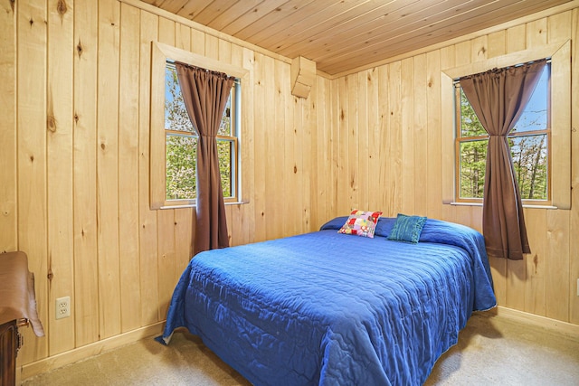 4900 N Railroad Ave, Pentwater, MI 49449 - carpeted bedroom featuring wood walls, wood ceiling, and baseboards