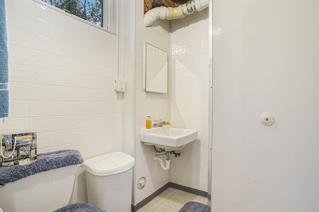 4900 N Railroad Ave, Pentwater, MI 49449 - half bathroom featuring toilet and tile walls