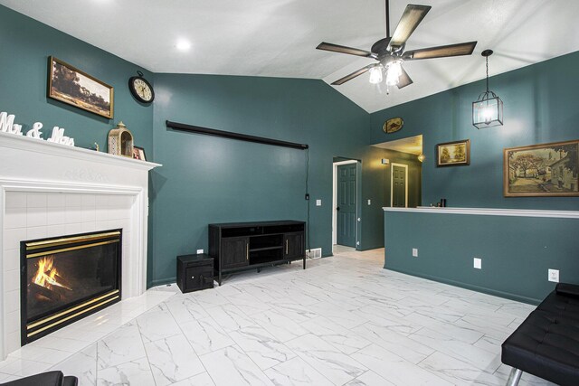 11199 W Harlow Rd, Greenville, MI 48838 - living area with ceiling fan, lofted ceiling, marble look tile flooring, a tile fireplace, and baseboards