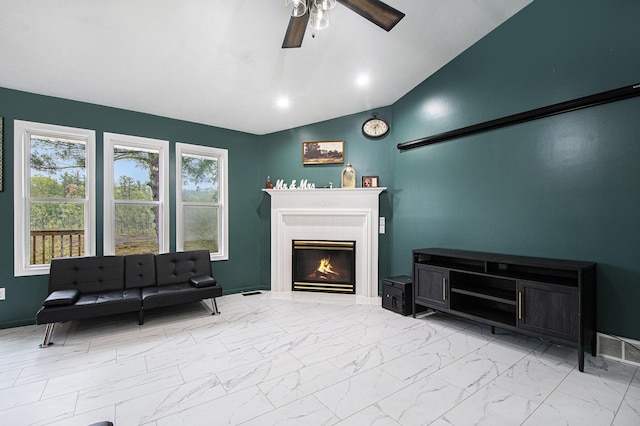 11199 W Harlow Rd, Greenville, MI 48838 - living area featuring a ceiling fan, lofted ceiling, light marble finish flooring, and a warm lit fireplace
