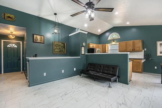 11199 W Harlow Rd, Greenville, MI 48838 - kitchen with a ceiling fan, brown cabinets, light marble finish flooring, lofted ceiling, and baseboards