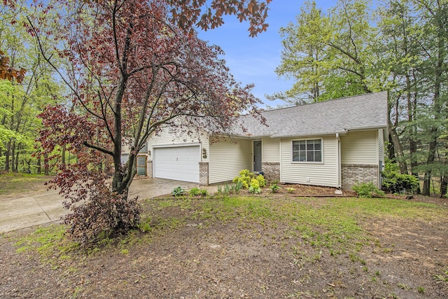 11199 W Harlow Rd, Greenville, MI 48838 - view of front of home with an attached garage, brick siding, concrete driveway, and roof with shingles