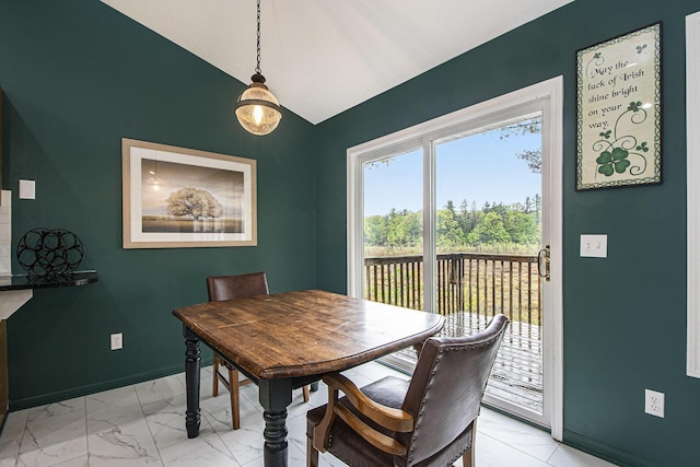11199 W Harlow Rd, Greenville, MI 48838 - dining space with light marble finish floors, baseboards, and lofted ceiling