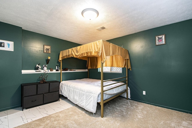 11199 W Harlow Rd, Greenville, MI 48838 - bedroom with marble look tiles, a textured ceiling, and baseboards