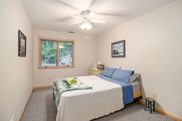 6818 W Vesper Dr, Ludington, MI 49431 - bedroom featuring light carpet, baseboards, and ceiling fan