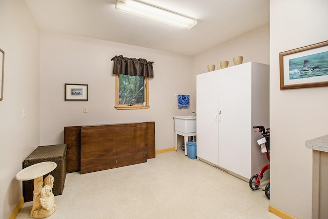 6818 W Vesper Dr, Ludington, MI 49431 - carpeted bedroom featuring baseboards and a sink