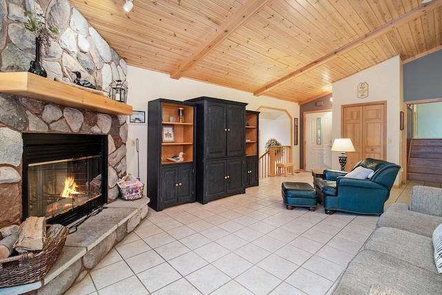 6818 W Vesper Dr, Ludington, MI 49431 - living area featuring light tile patterned floors, a stone fireplace, and wooden ceiling