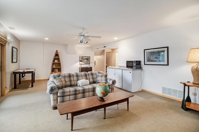 6818 W Vesper Dr, Ludington, MI 49431 - living area with light colored carpet, ceiling fan, baseboards, and recessed lighting