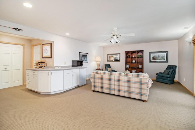 6818 W Vesper Dr, Ludington, MI 49431 - living area with light carpet, ceiling fan, recessed lighting, and baseboards