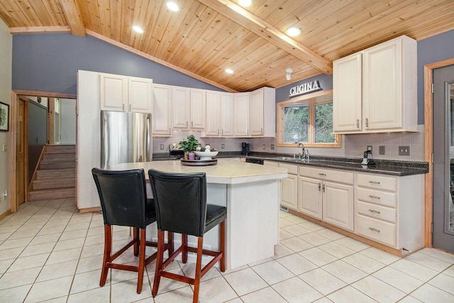 6818 W Vesper Dr, Ludington, MI 49431 - kitchen featuring wooden ceiling, light tile patterned floors, decorative backsplash, a kitchen island, and a breakfast bar