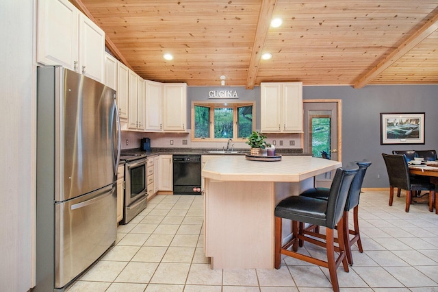 6818 W Vesper Dr, Ludington, MI 49431 - kitchen with appliances with stainless steel finishes, light tile patterned floors, wooden ceiling with exposed beams, a breakfast bar, and a center island