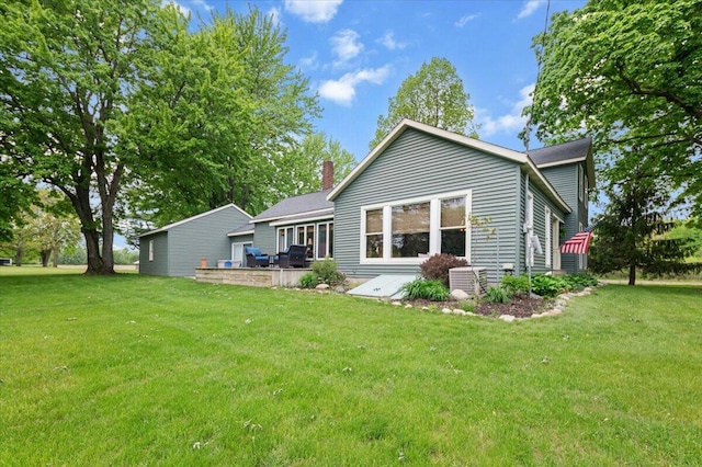 11087 Phelps Ave NW, Sparta, MI 49345 - rear view of house with a lawn and a chimney