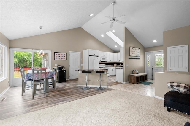 306 Meister Rd, Fremont, MI 49412 - dining area with ceiling fan, healthy amount of natural light, baseboards, high vaulted ceiling, and recessed lighting