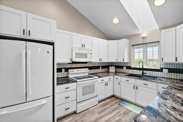 306 Meister Rd, Fremont, MI 49412 - kitchen featuring white appliances, a sink, vaulted ceiling, white cabinets, and decorative backsplash