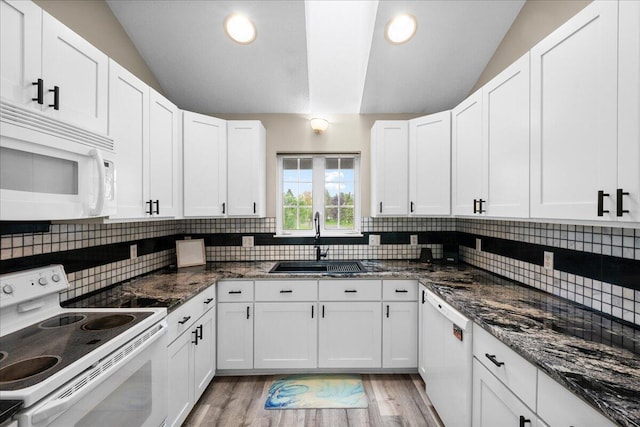 306 Meister Rd, Fremont, MI 49412 - kitchen with white appliances, a sink, tasteful backsplash, vaulted ceiling, and white cabinets