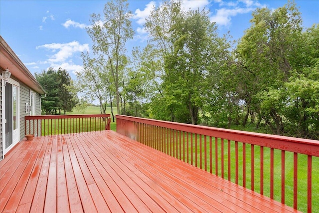 306 Meister Rd, Fremont, MI 49412 - wooden terrace with a lawn and view of wooded area