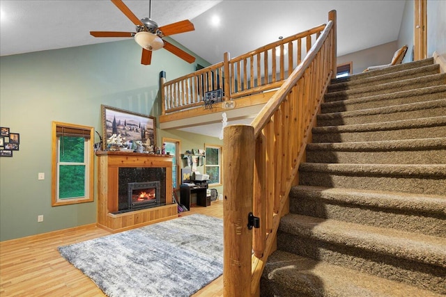 65 N Brown Rd, Bailey, MI 49303 - staircase with wood finished floors, ceiling fan, a fireplace, and high vaulted ceiling