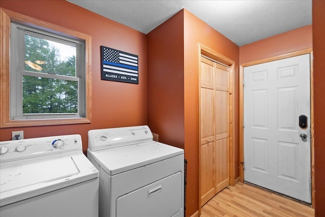 65 N Brown Rd, Bailey, MI 49303 - laundry room featuring separate washer and dryer, light wood finished floors, and a textured ceiling