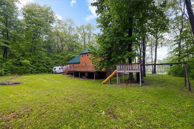 65 N Brown Rd, Bailey, MI 49303 - view of green lawn with a deck