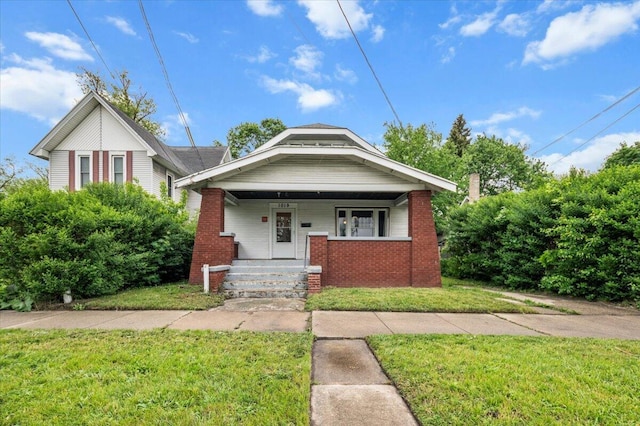 1019 Second St NW, Grand Rapids, MI 49504 - bungalow-style home featuring a front lawn, brick siding, and a porch
