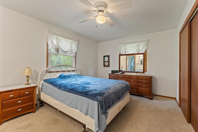 70594 Dennis Dr, Niles, MI 49120 - bedroom with light colored carpet, a closet, a ceiling fan, and baseboards