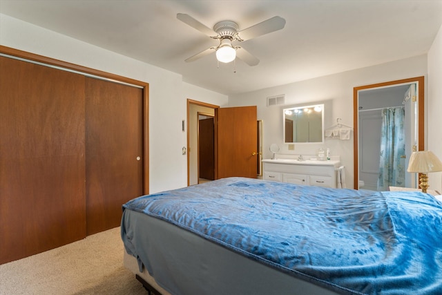 70594 Dennis Dr, Niles, MI 49120 - carpeted bedroom with a closet, connected bathroom, a ceiling fan, and a sink