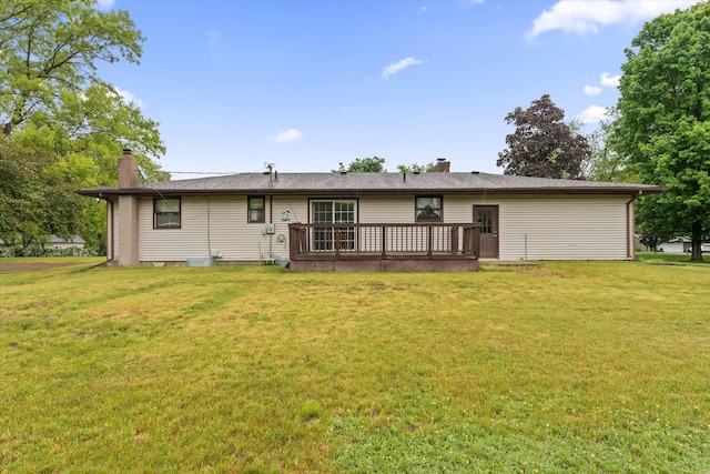 70594 Dennis Dr, Niles, MI 49120 - back of property with a chimney, a wooden deck, and a lawn