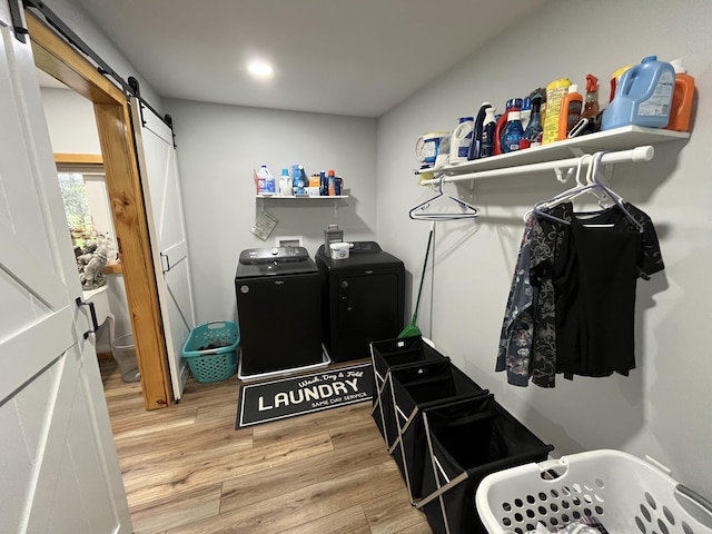 550 E N St, Edmore, MI 48829 - washroom featuring a barn door, light wood finished floors, independent washer and dryer, and recessed lighting