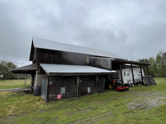 550 E N St, Edmore, MI 48829 - rear view of property with an outdoor structure, metal roof, a yard, and a pole building