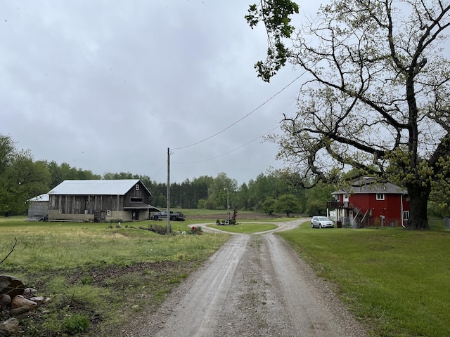 550 E N St, Edmore, MI 48829 - view of dirt / gravel road featuring a barn