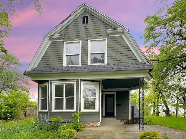 93 Goguac St E, Battle Creek, MI 49015 - view of front of house with a shingled roof and a porch
