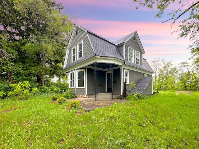 93 Goguac St E, Battle Creek, MI 49015 - view of front of home with a patio area, roof with shingles, and a gambrel roof