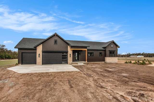 0 Baldwin St, Hudsonville, MI 49426 - modern farmhouse style home featuring concrete driveway, a shingled roof, and an attached garage