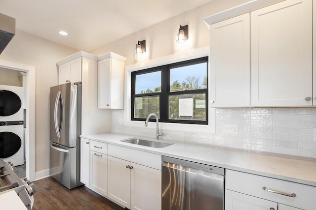 0 Baldwin St, Hudsonville, MI 49426 - kitchen with appliances with stainless steel finishes, stacked washer / drying machine, a sink, decorative backsplash, and recessed lighting