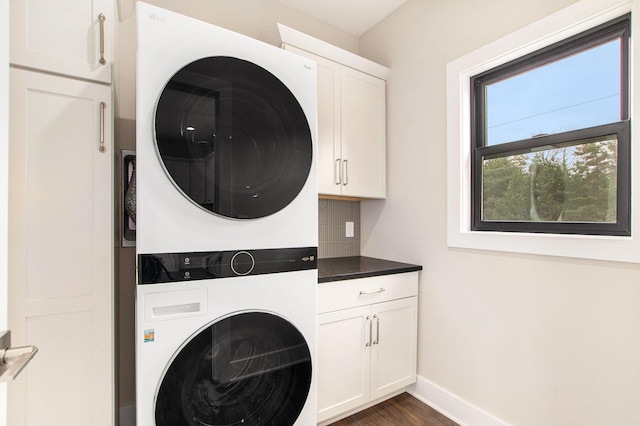 0 Baldwin St, Hudsonville, MI 49426 - laundry area with stacked washer / drying machine, cabinet space, baseboards, and dark wood-type flooring