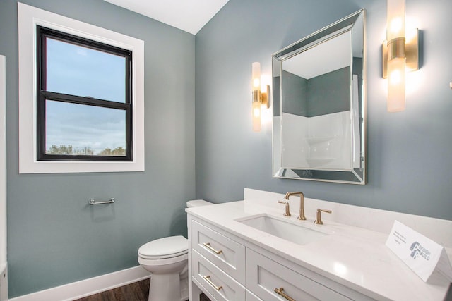 0 Baldwin St, Hudsonville, MI 49426 - bathroom with toilet, vanity, wood finished floors, and baseboards
