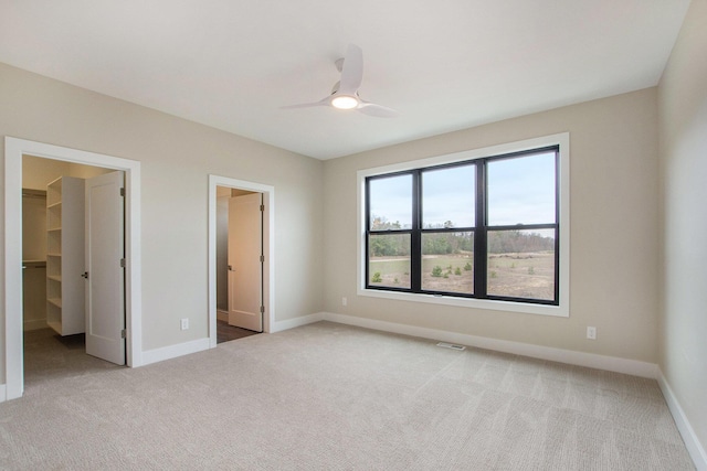 0 Baldwin St, Hudsonville, MI 49426 - unfurnished bedroom with carpet floors, a spacious closet, baseboards, and ceiling fan