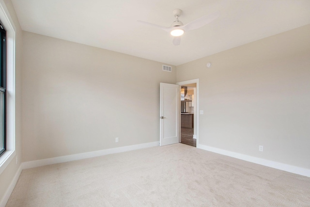 0 Baldwin St, Hudsonville, MI 49426 - empty room featuring light carpet, a ceiling fan, and baseboards