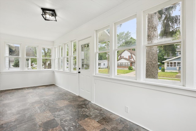 2218 Dalton Ave SW, Wyoming, MI 49519 - unfurnished sunroom with stone finish floors and healthy amount of natural light