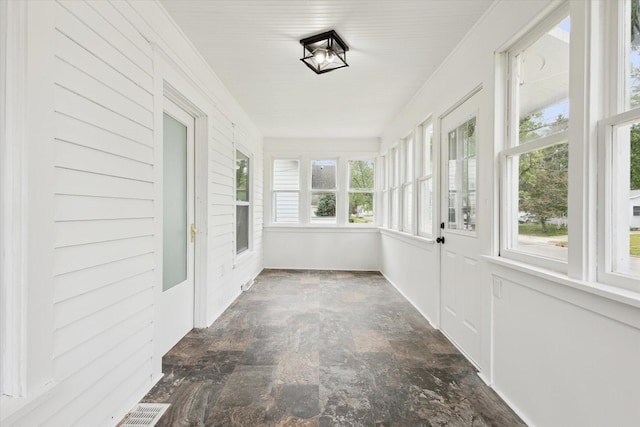 2218 Dalton Ave SW, Wyoming, MI 49519 - unfurnished sunroom featuring stone finish flooring