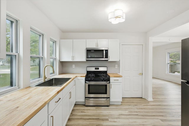 2218 Dalton Ave SW, Wyoming, MI 49519 - kitchen with stainless steel appliances, butcher block counters, a sink, and light wood finished floors