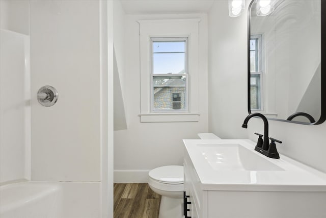 2218 Dalton Ave SW, Wyoming, MI 49519 - bathroom featuring vanity, wood finished floors, baseboards, toilet, and a shower