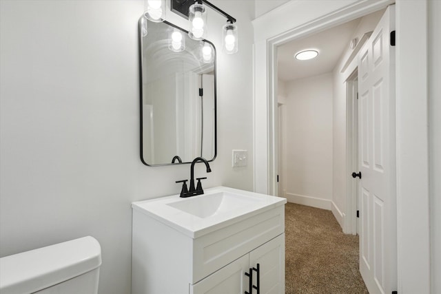 2218 Dalton Ave SW, Wyoming, MI 49519 - bathroom featuring vanity, toilet, and baseboards